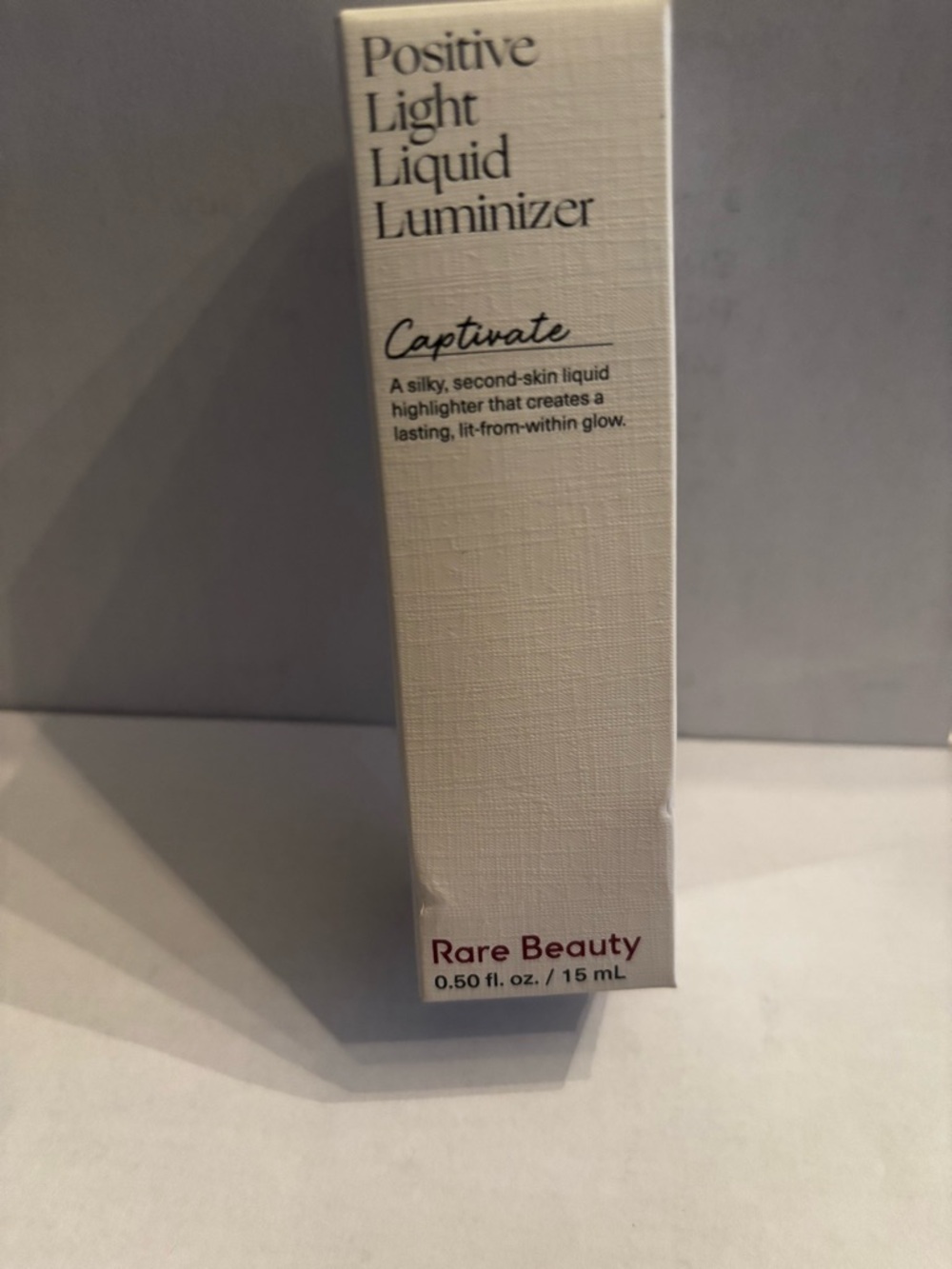 Rare Beauty Positive Light Liquid Luminizer - Captivate (copper)